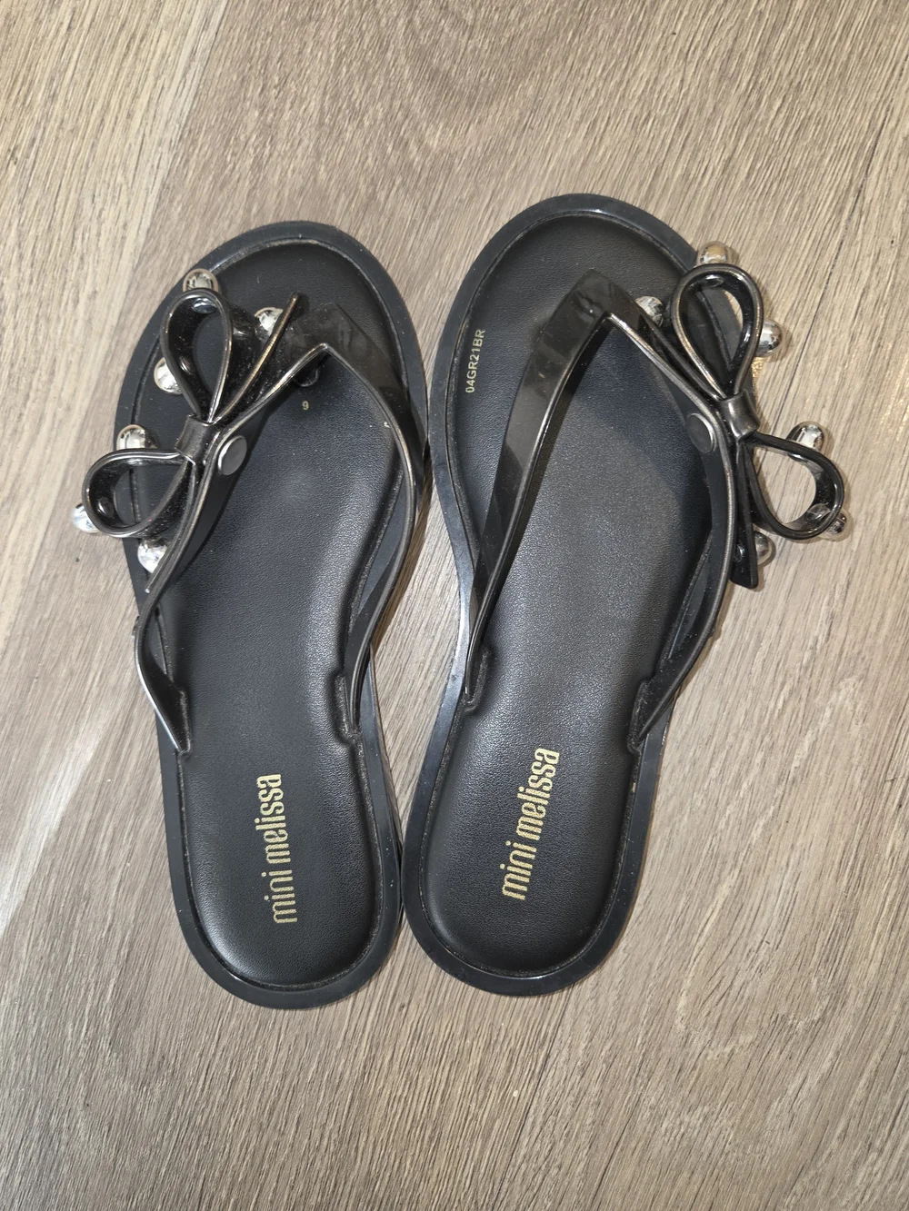 Mini Melissa Black Jelly Bow Flip Sandals with Silver Accent Ornaments
